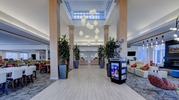 A spacious lobby with a high ceiling, modern lighting fixtures, and a central reception area. - Hilton Garden Inn Anaheim Garden Grove (Garden Grove)