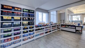 A spacious retail store with wide aisles and high shelves stocked with various snacks and beverages. - Hilton Garden Inn Anaheim Garden Grove (Garden Grove)