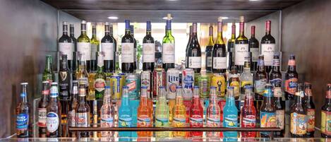 A bar with a variety of alcoholic beverages, including wine and beer.