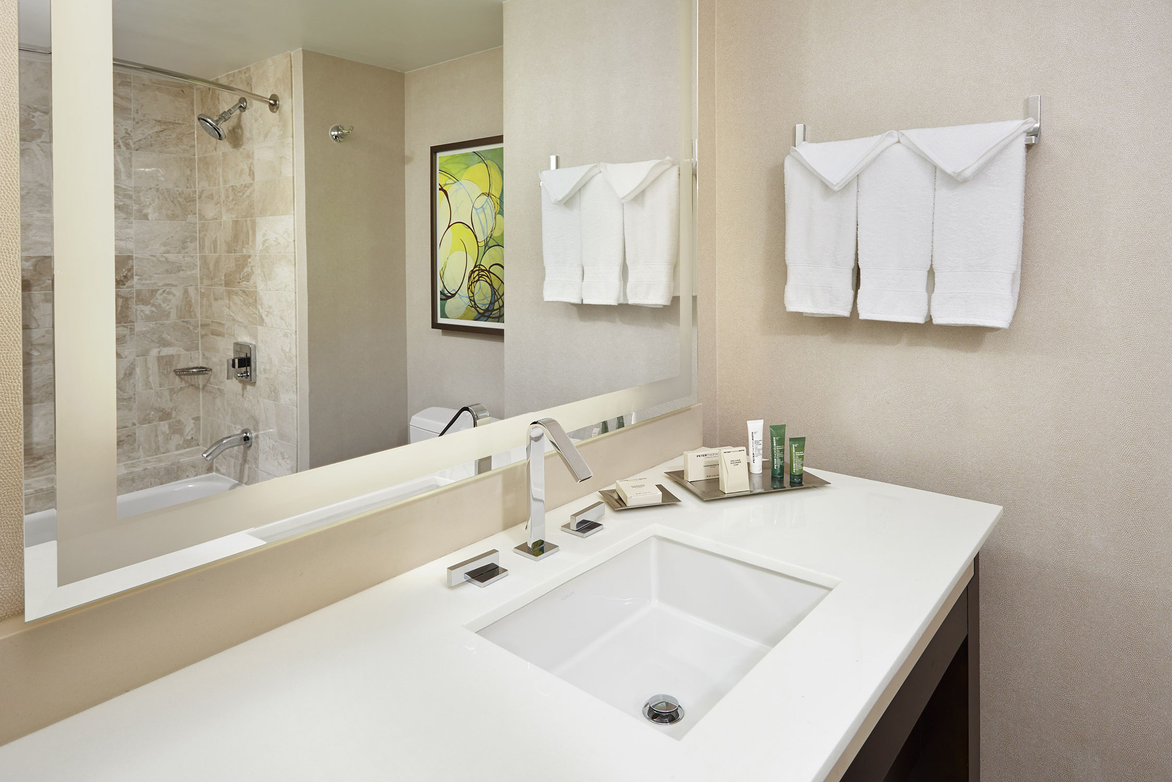 combined shower/bathtub, designer toiletries, hair dryer, towels