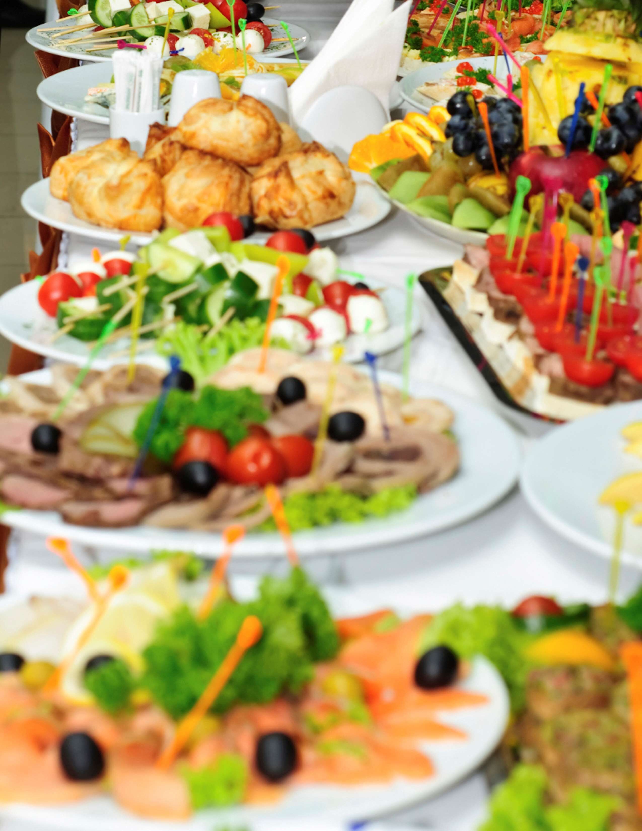 A buffet with various dishes including salads, meats, and seafood.