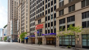 A Hilton Garden Inn hotel with a modern facade, large windows, and a prominent sign. - Hilton Garden Inn Chicago Downtown/Magnificent Mile (Chicago)