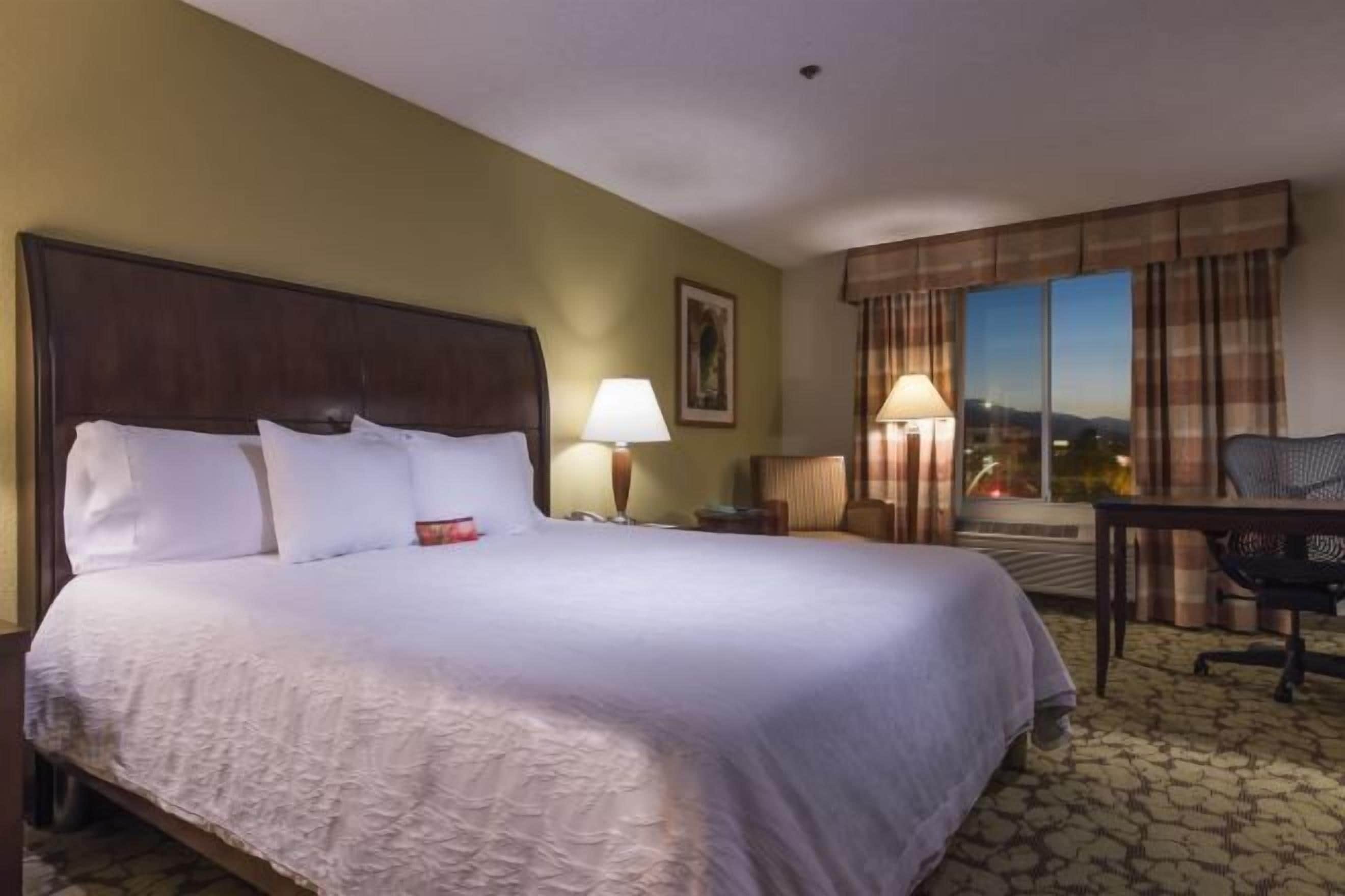 Desk, laptop workspace, blackout drapes, iron/ironing board