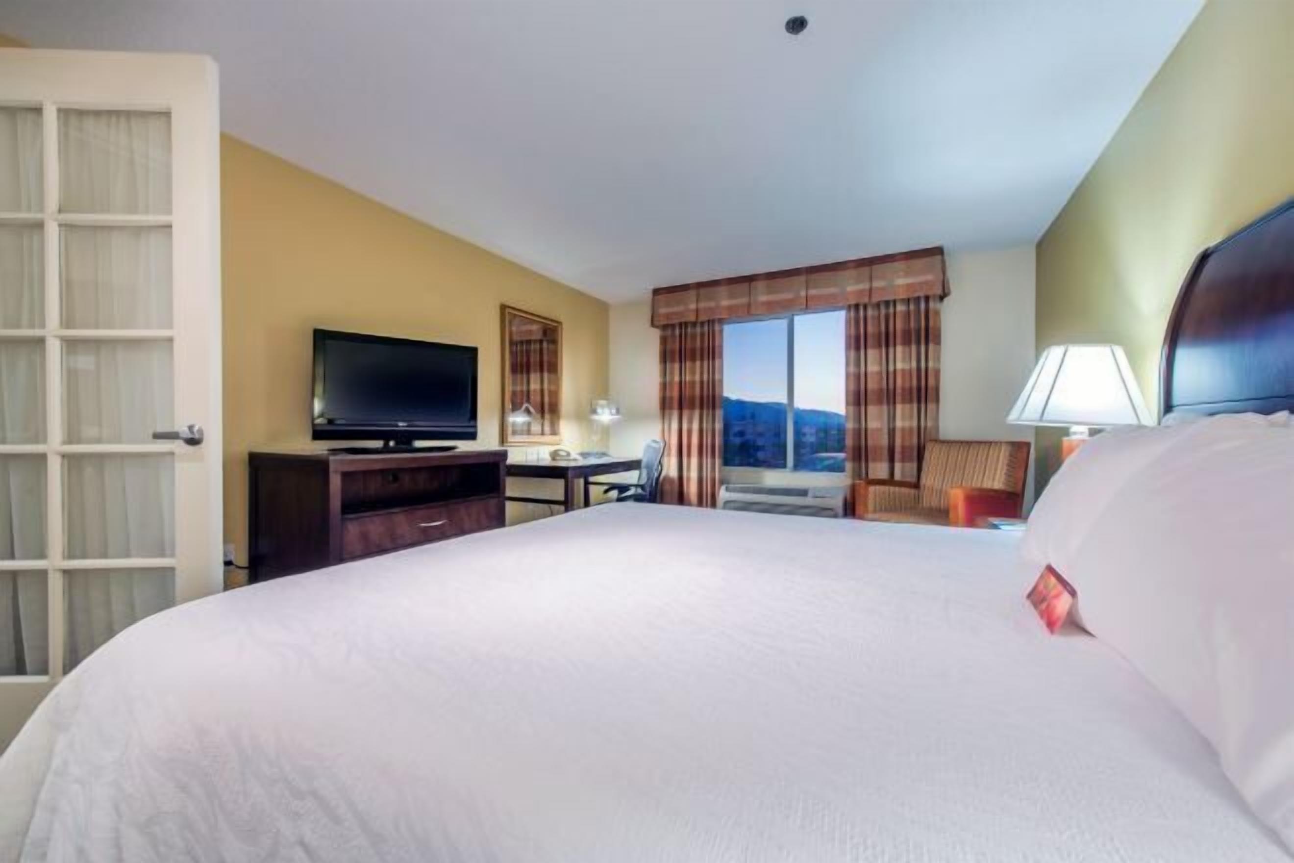 Desk, laptop workspace, blackout drapes, iron/ironing board