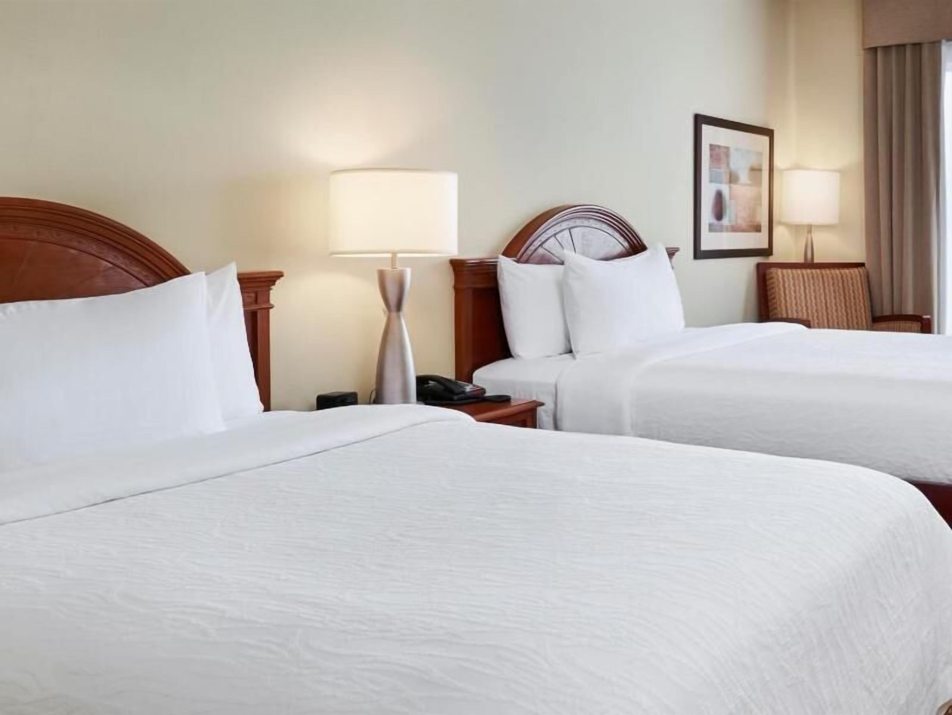 Premium bedding, desk, laptop workspace, blackout drapes