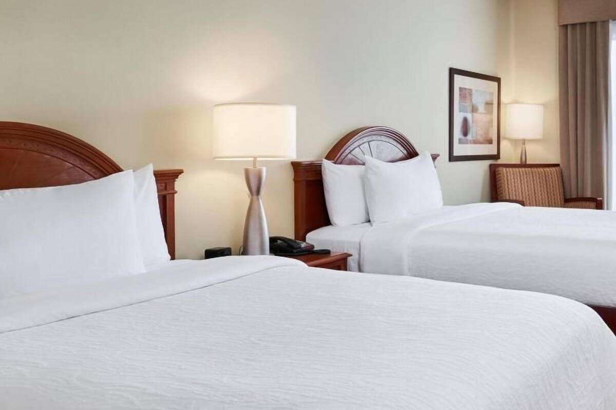 Premium bedding, desk, laptop workspace, blackout drapes