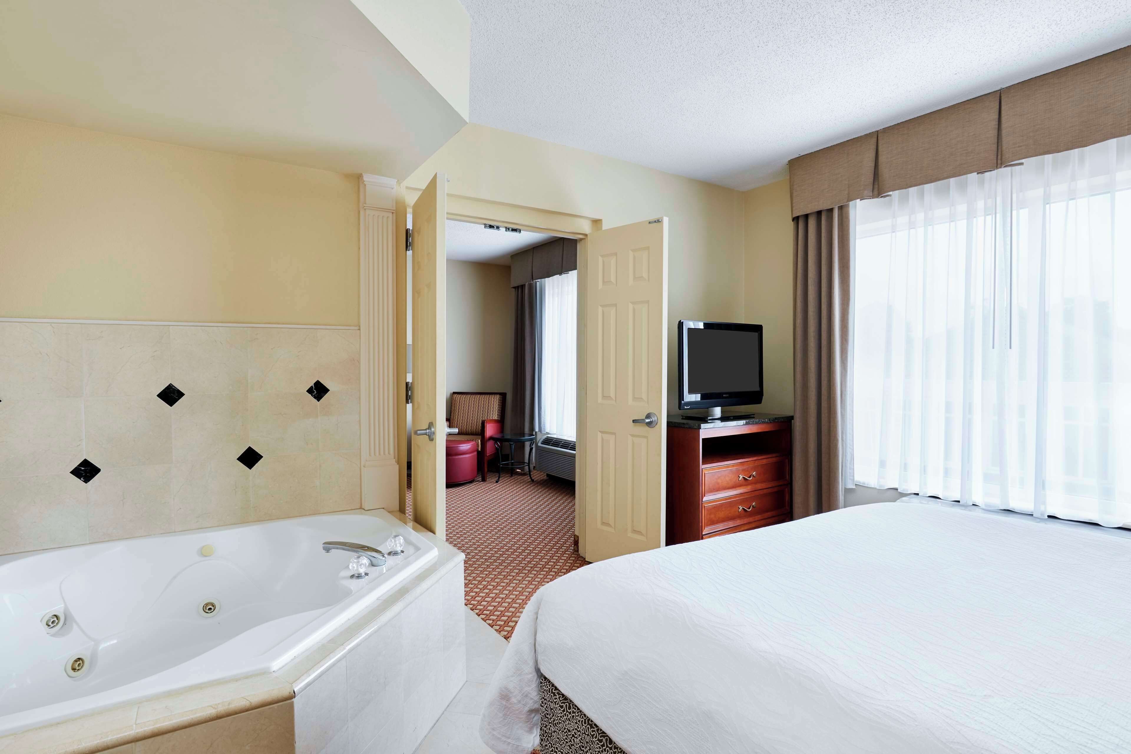 suite, 1 king bed, jetted tub | 1 bedroom, premium bedding, desk, laptop workspace