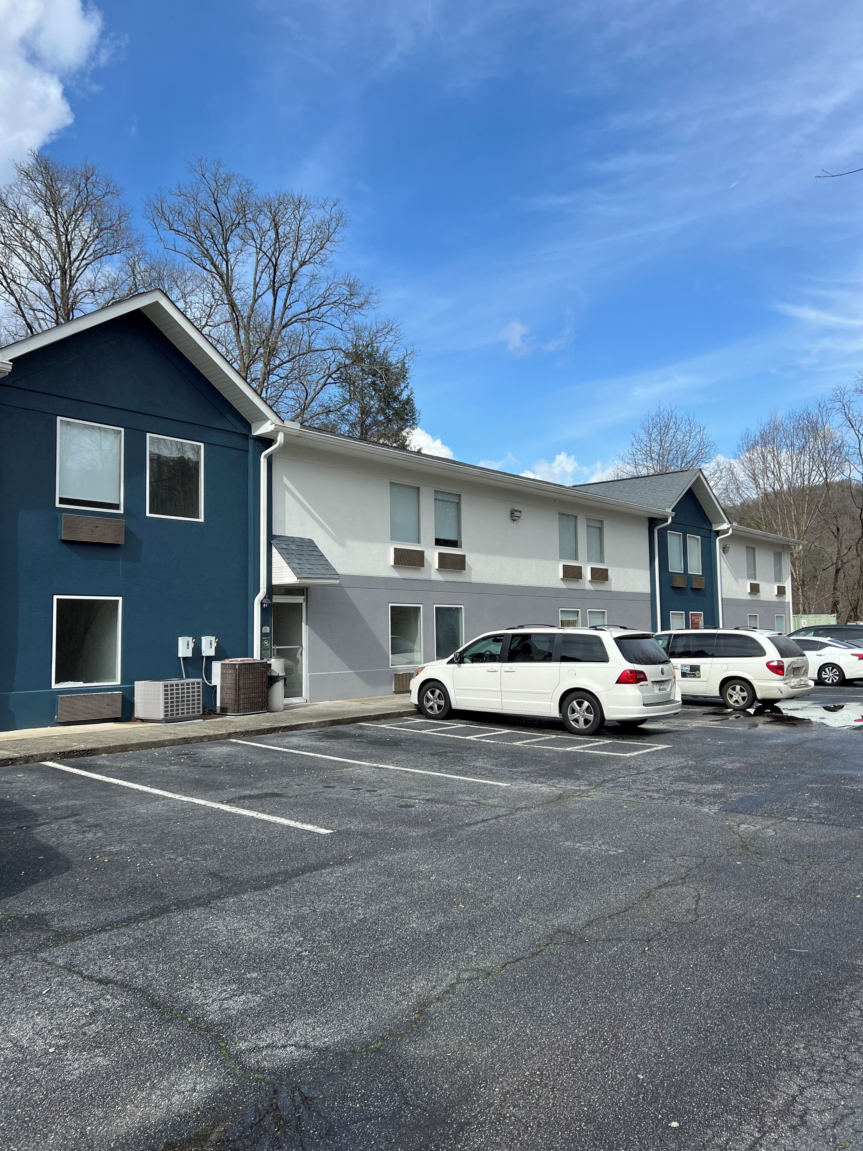A two-story building with a parking lot.