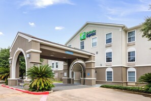 A Holiday Inn Express building with a covered entrance, clear signage, and a parking lot. - Holiday Inn Express Hotel & Suites Columbus by IHG (Columbus)