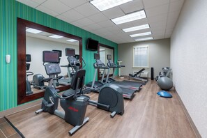 A gym with cardio machines, a mirrored wall, and a large window. - Holiday Inn Express State College at Williamsburg Square by IHG (State College)