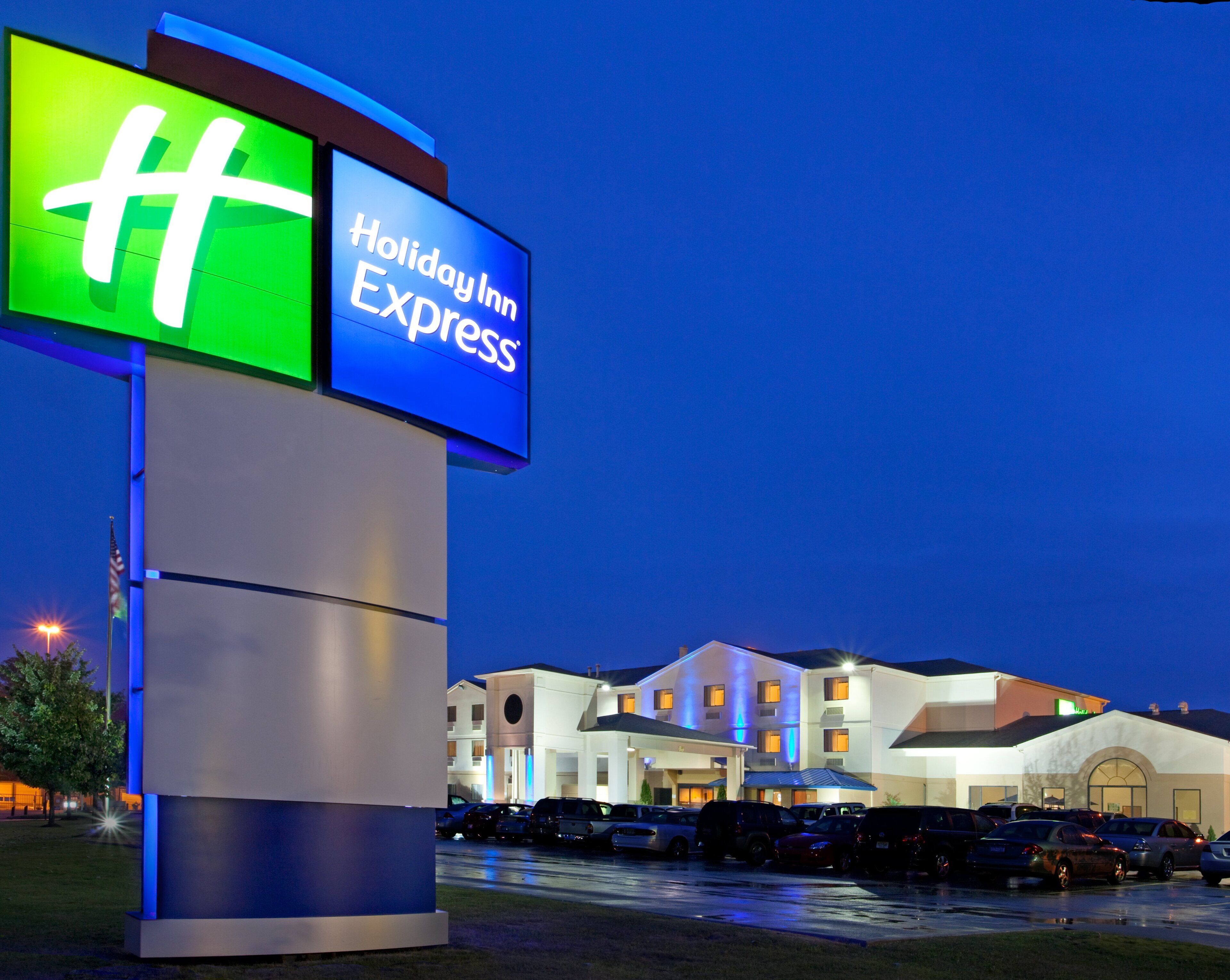 A Holiday Inn Express sign with a modern building in the background.