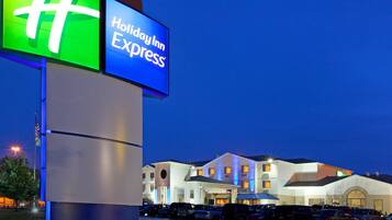 A Holiday Inn Express sign with a modern building in the background.