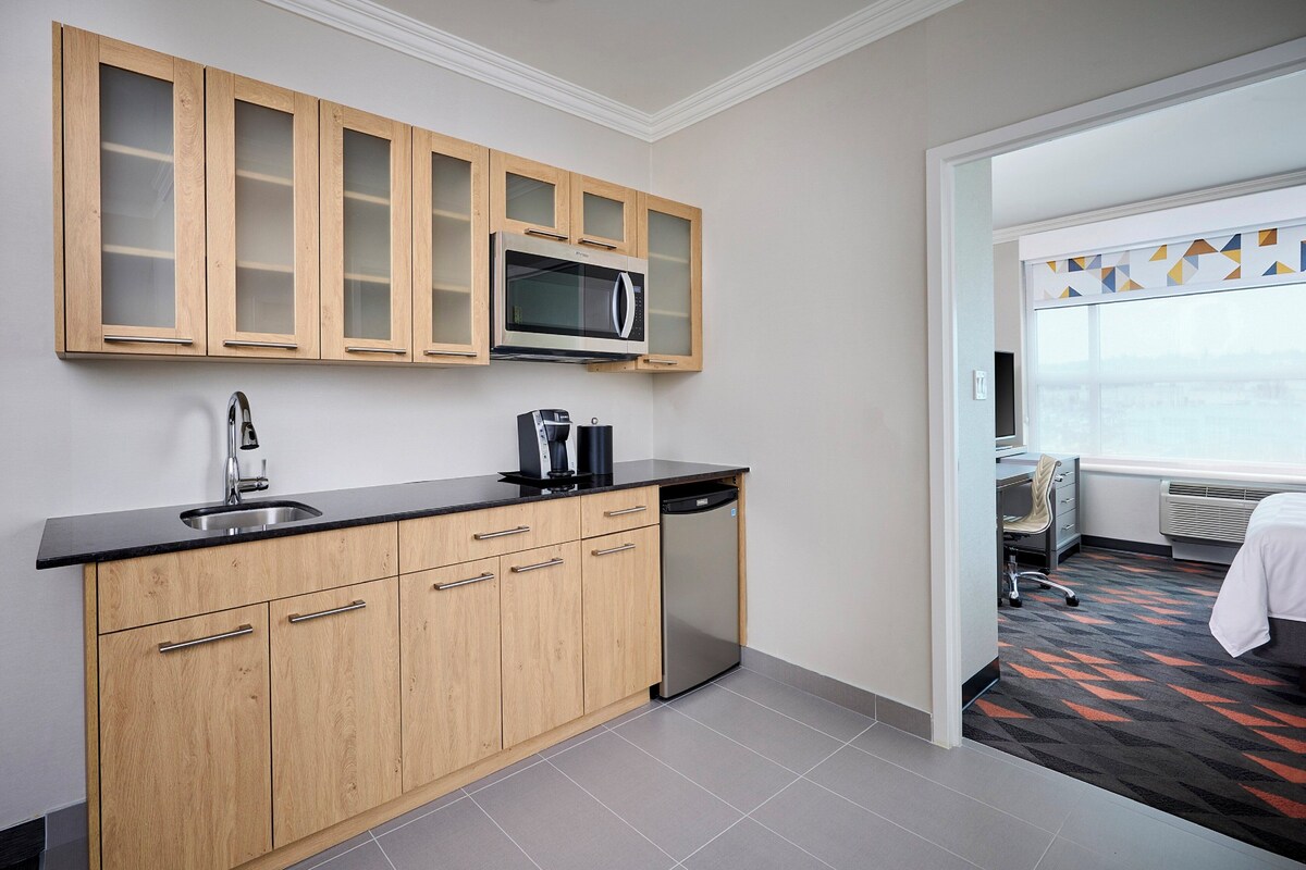 A modern kitchen with a microwave, coffee maker, and dishwasher.