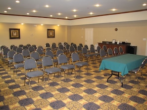 A conference room with rows of chairs, a table, and a podium. - Holiday Inn Express Hotel & Suites Kilgore by IHG (Kilgore)