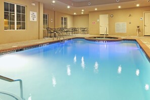 A swimming pool with a diving sign, a clock, and a sign indicating a restroom. - Holiday Inn Express Hotel & Suites Kilgore by IHG (Kilgore)