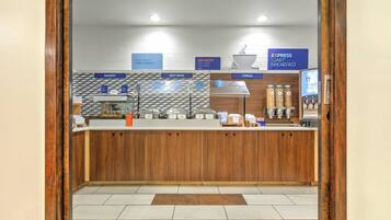 A breakfast counter with labeled sections for bakery, hot food, and cereal.