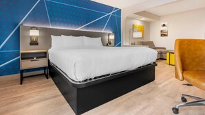 A modern hotel room with a bed, bedside tables, a desk, and a chair. - Comfort Inn & Suites Saint Louis Lafayette Square (St. Louis)