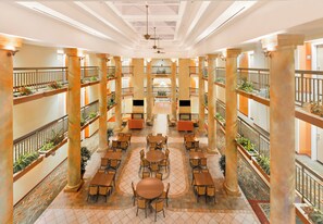 A multi-level atrium with open-plan seating and decorative columns. - Holiday Inn Express Hotel & Suites San Jose-Morgan Hill by IHG (Morgan Hill)