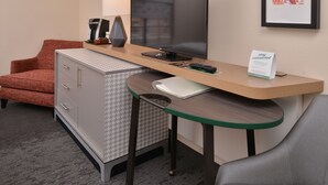 A hotel room with a desk, a television, a coffee maker, a lamp, and a sign that says "stay connected." - Holiday Inn Hotel & Suites Raleigh / Cary by IHG (Cary)