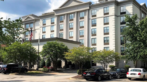 A multi-story hotel with a symmetrical facade, large windows, and a central entrance. - Holiday Inn Hotel & Suites Raleigh / Cary by IHG (Cary)