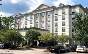 A multi-story hotel with a symmetrical facade, large windows, and a central entrance.