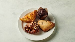 A plate with four pastries on a white plate. - Holiday Inn Hotel & Suites Raleigh / Cary by IHG (Cary)