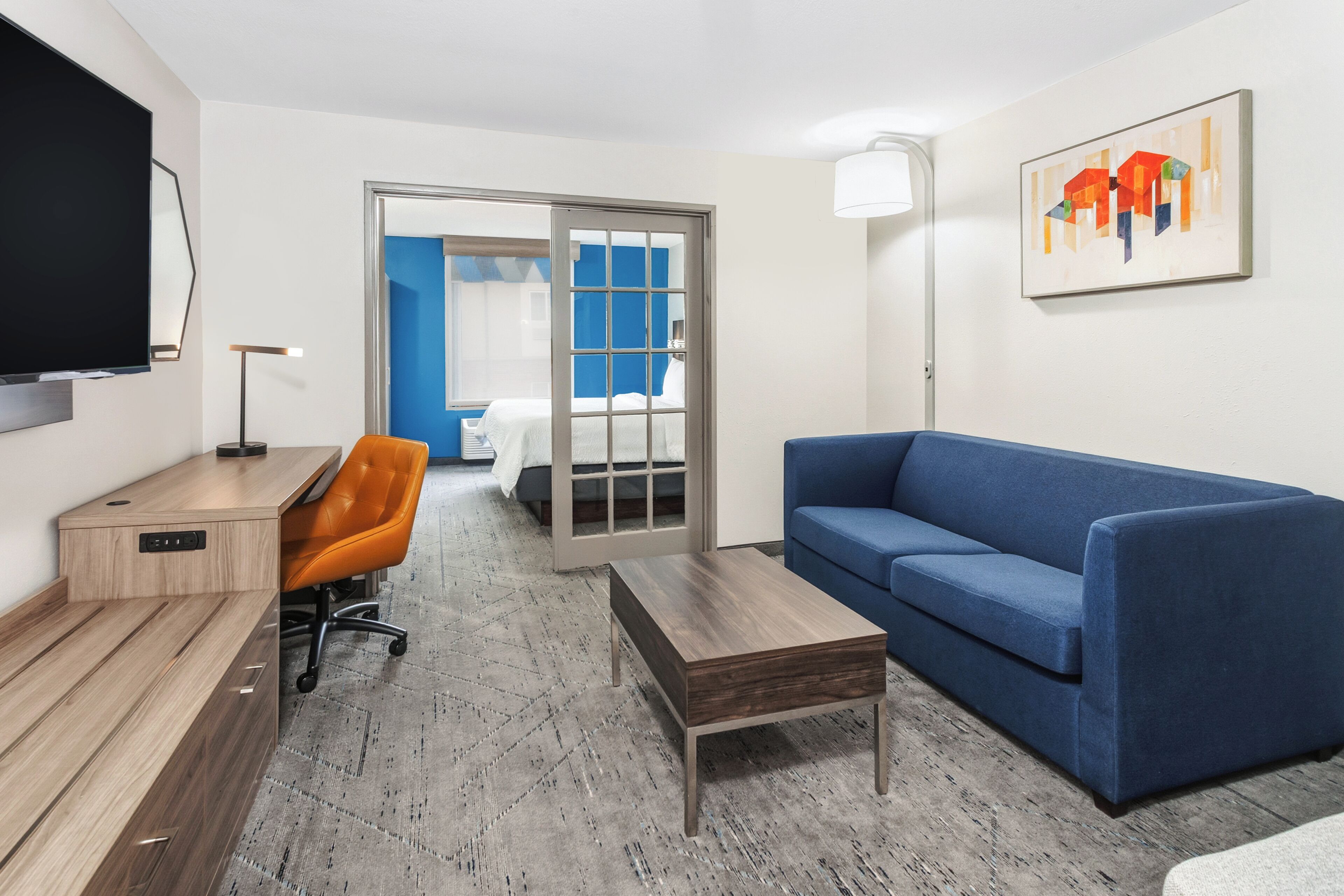 Premium bedding, desk, laptop workspace, blackout drapes