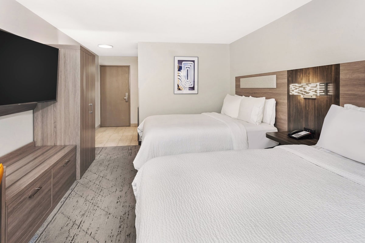 Premium bedding, desk, laptop workspace, blackout curtains