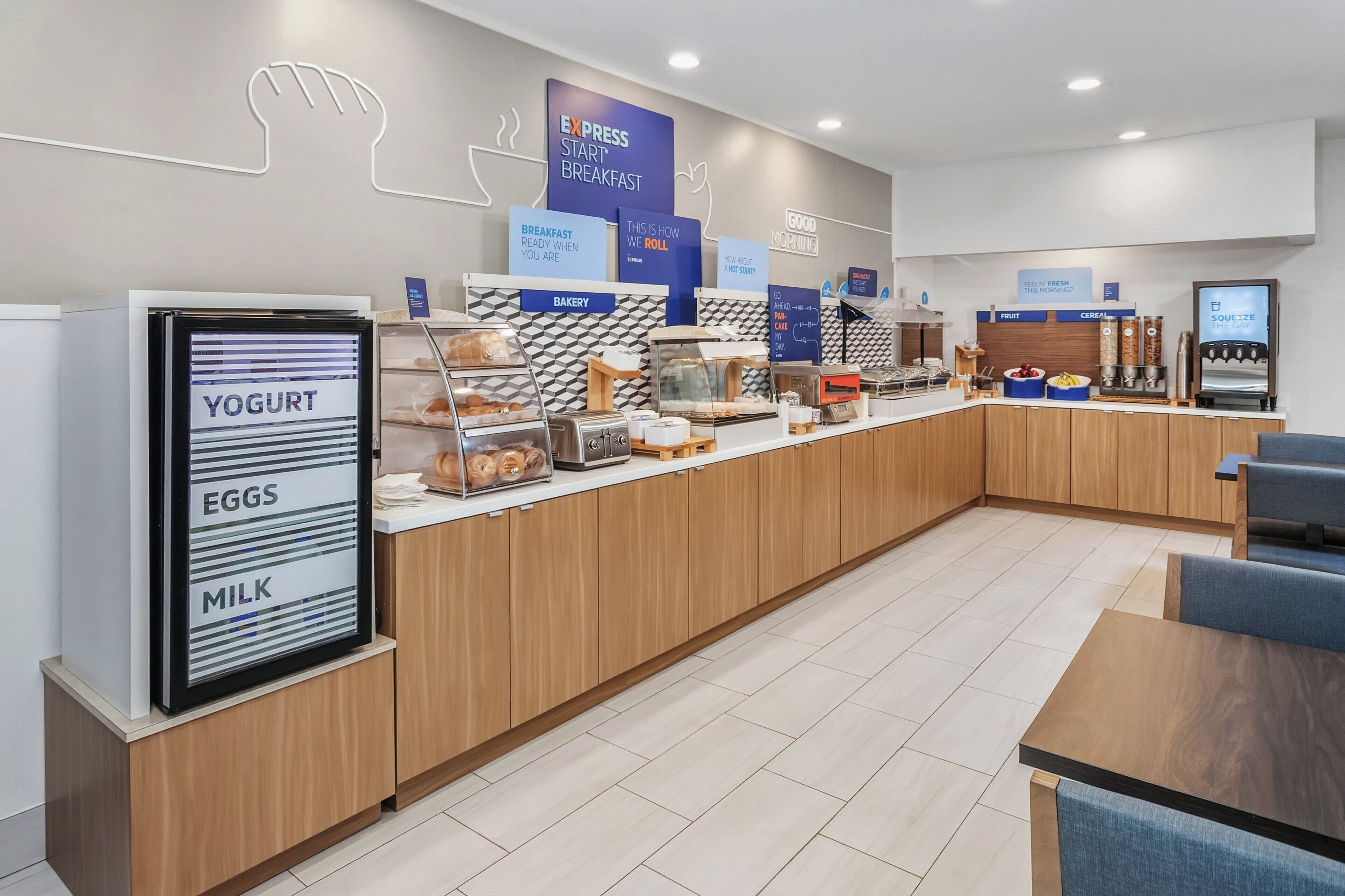 A modern breakfast area with a self-serve station for yogurt, eggs, and milk.