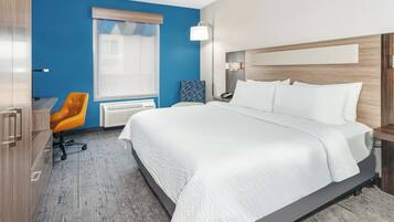 Premium bedding, desk, laptop workspace, blackout drapes