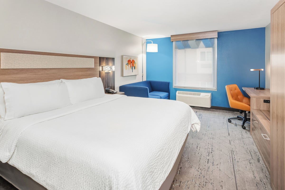 Premium bedding, desk, laptop workspace, blackout drapes