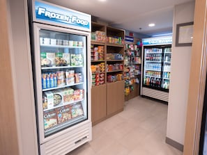 A frozen food section with various packaged goods and a nearby express shop. - Holiday Inn Express Hotel & Suites Frackville by IHG (Frackville)