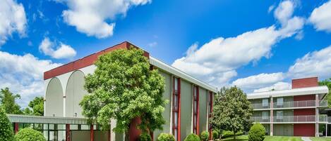 A modern building with a flat roof, large windows, and a central entrance.