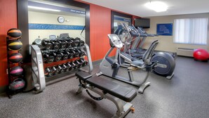A gym with various exercise equipment, including dumbbells, treadmills, and an elliptical trainer. - Hampton Inn Fremont (Fremont)