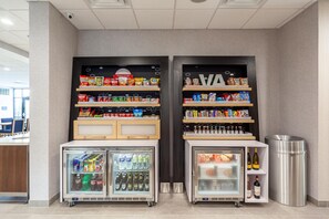 A vending area with snacks, drinks, and a beverage fridge. - Hampton Inn Winchester N/Conference Center, VA (Winchester)