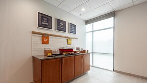 A modern kitchen with wooden cabinets, a countertop, and a window with a view. - Hampton Inn Winchester N/Conference Center, VA (Winchester)
