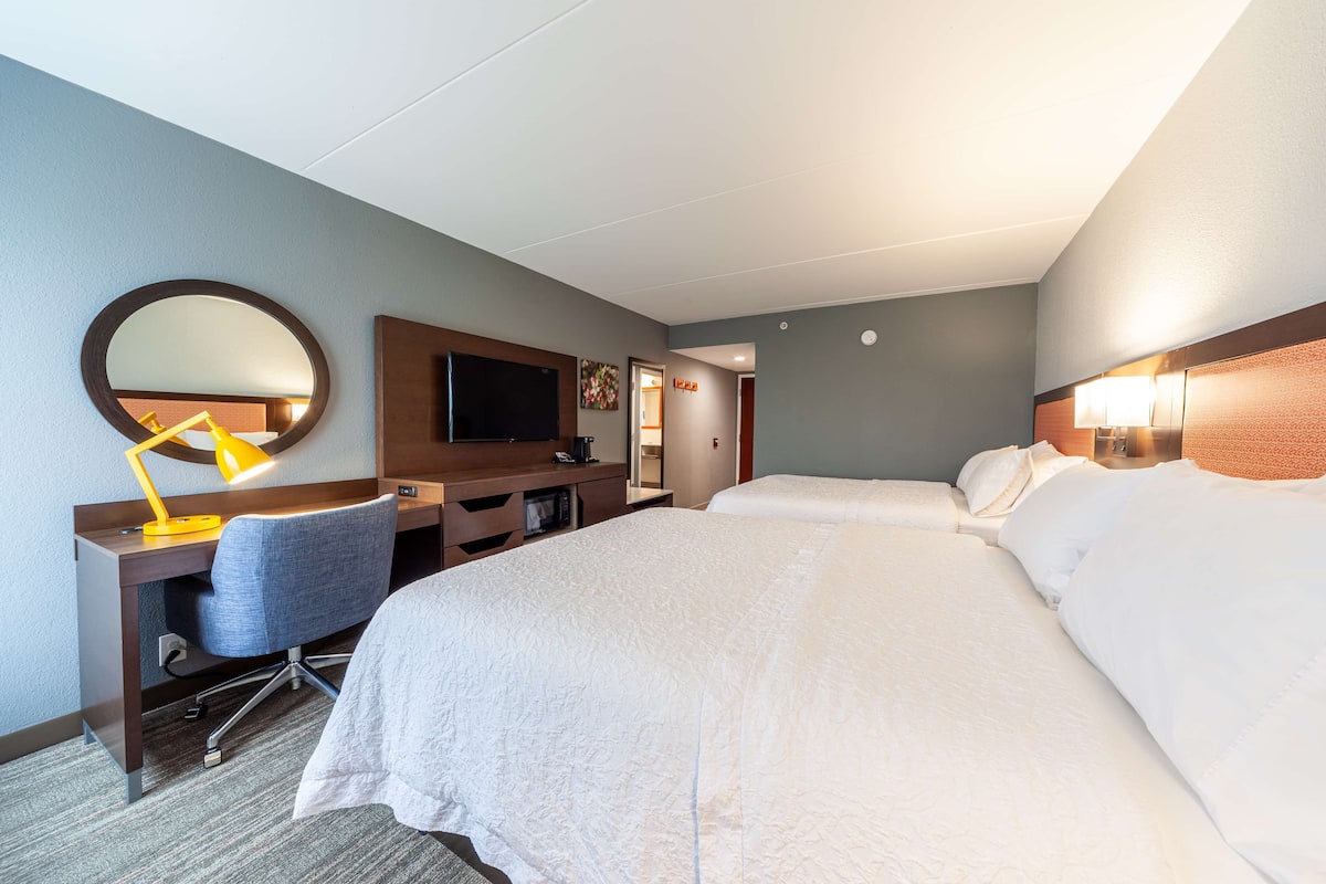Room, 2 Queen Beds, Non Smoking | Living area | 32-inch LCD TV with satellite channels, TV, MP3 dock