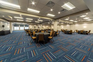 A large conference room with multiple tables and chairs, carpeted floor, and ceiling lights. - Hampton Inn Winchester N/Conference Center, VA (Winchester)