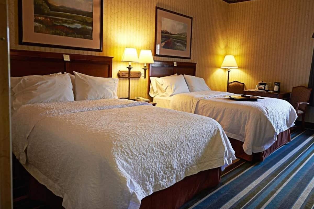 Premium bedding, pillow-top beds, desk, laptop workspace