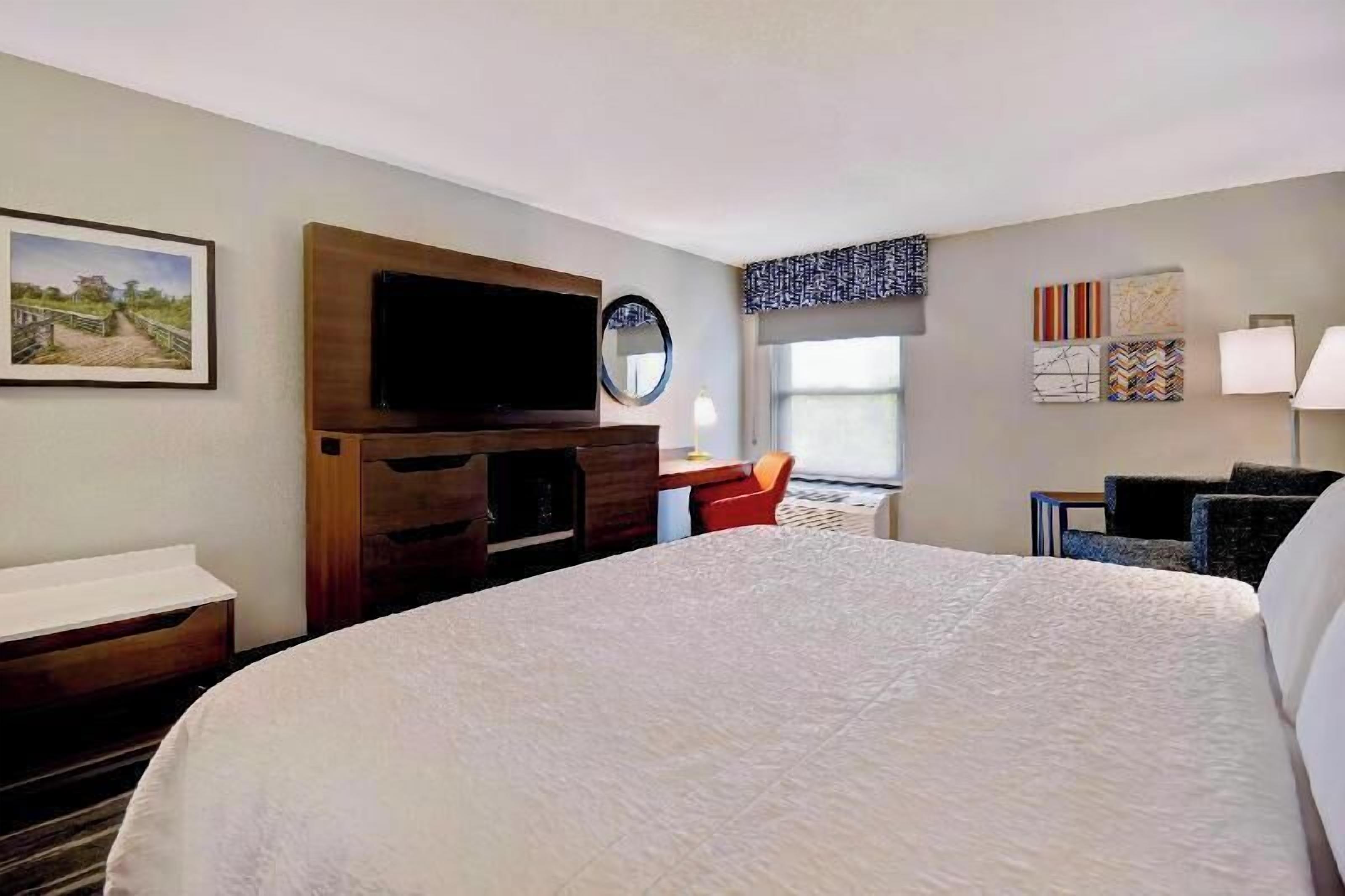 Premium bedding, desk, laptop workspace, blackout drapes