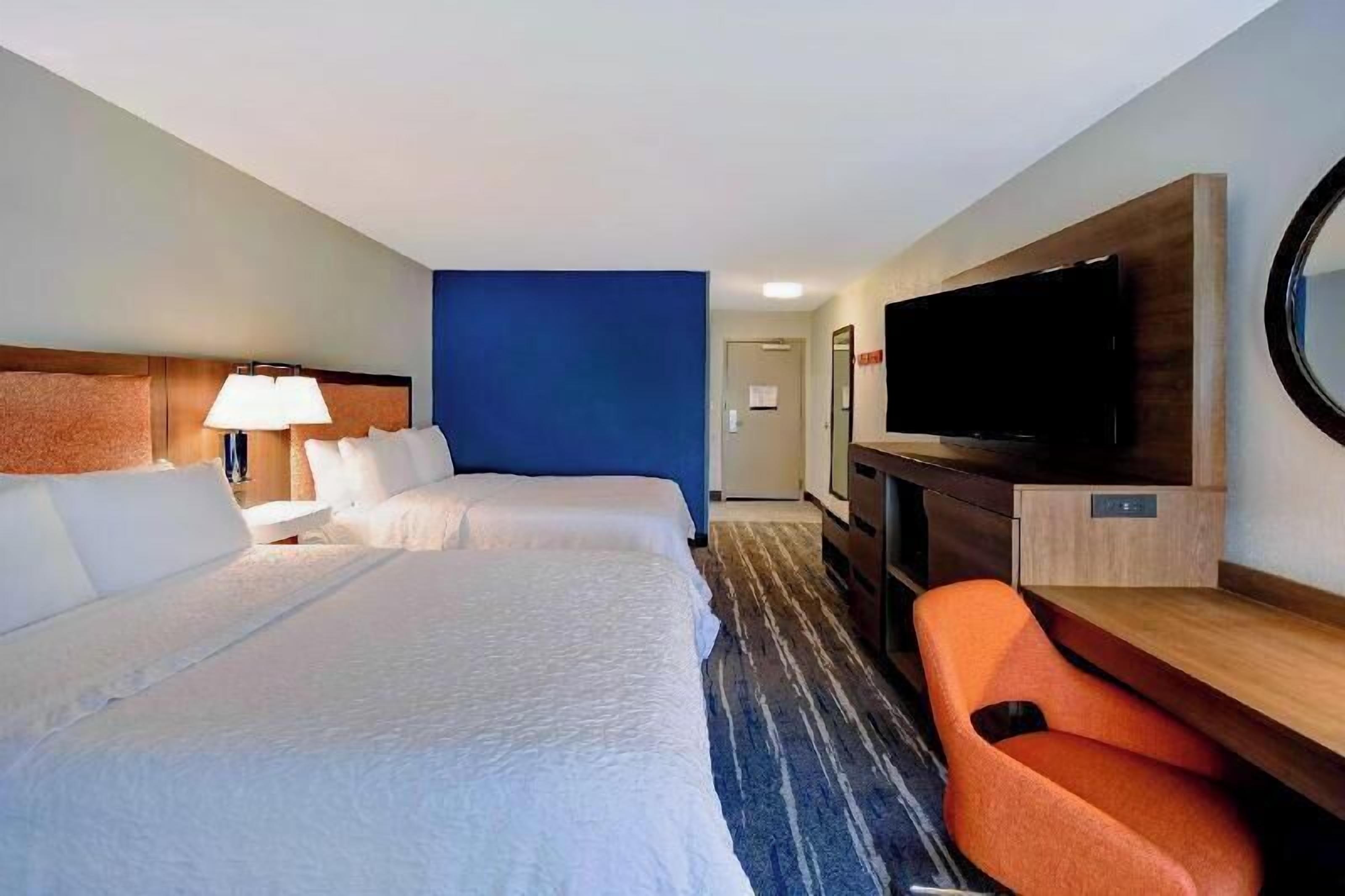Premium bedding, desk, laptop workspace, blackout drapes