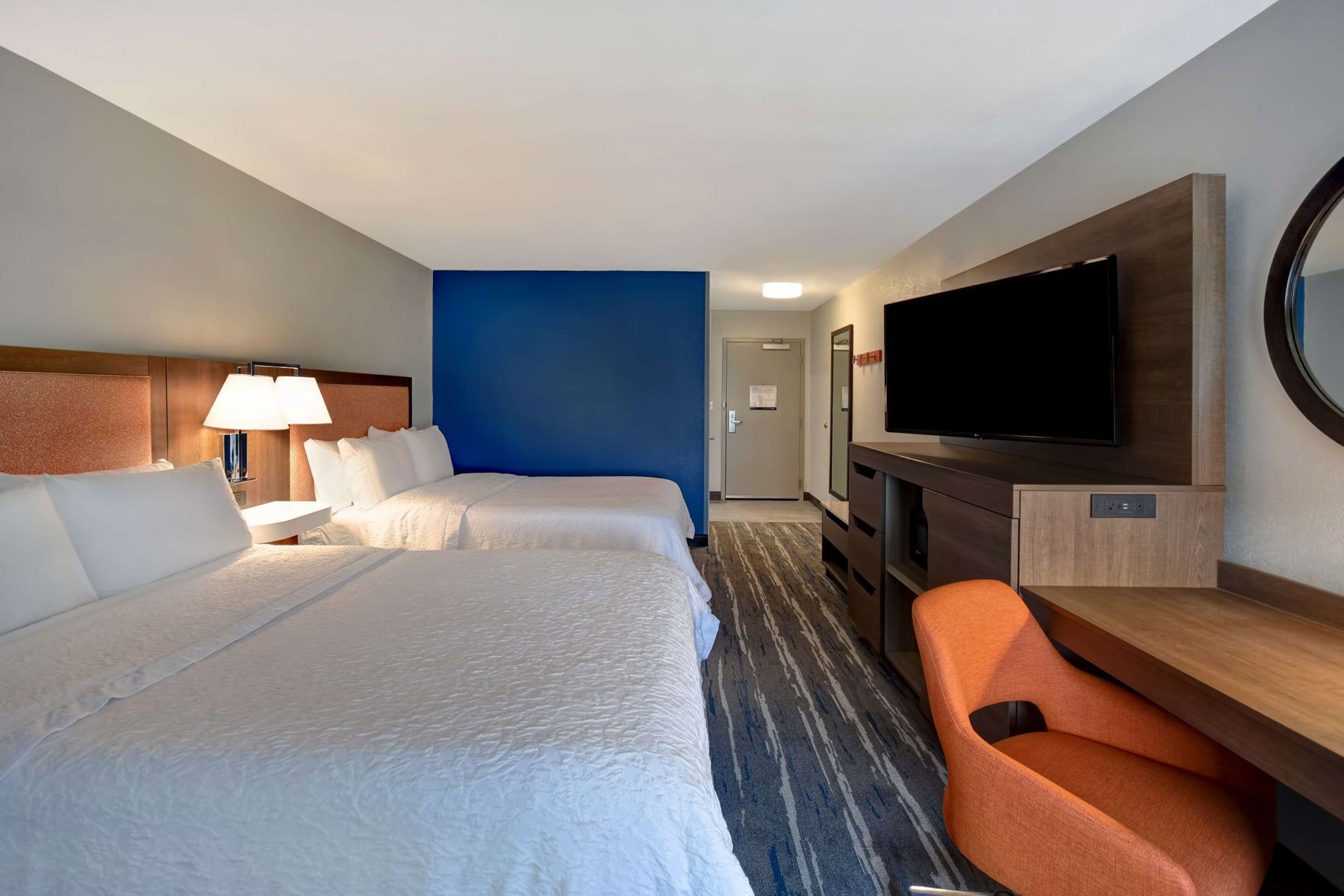 Premium bedding, desk, laptop workspace, blackout drapes