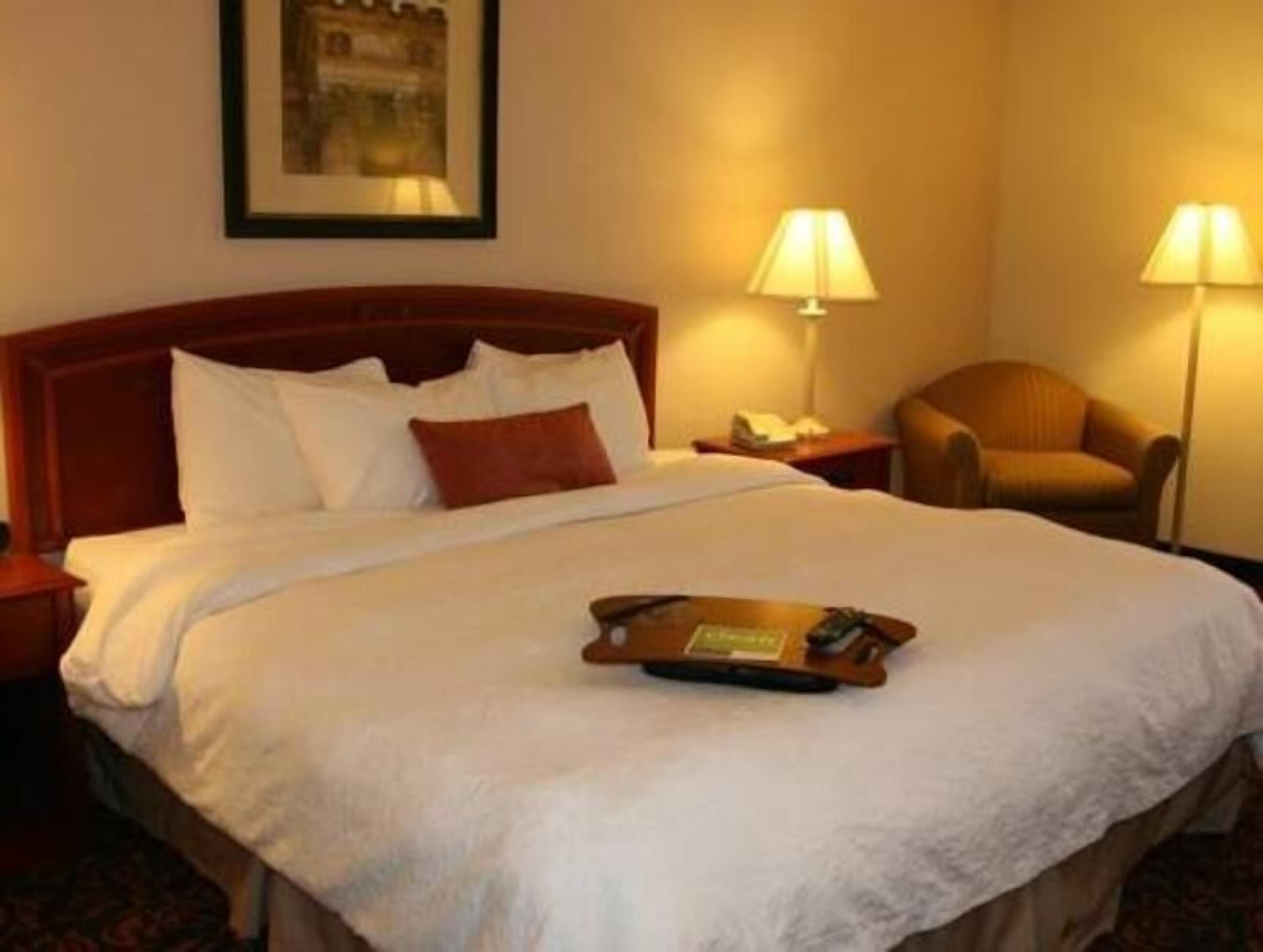 Premium bedding, desk, laptop workspace, blackout drapes