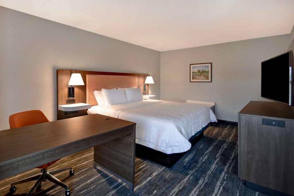 Premium bedding, desk, laptop workspace, blackout drapes