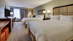 A hotel room with two beds, a desk with a TV, a chair, and a desk lamp. - Hampton Inn Warner Robins (Warner Robins)