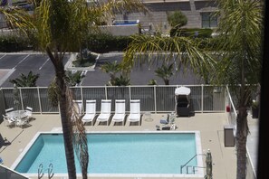 Outdoor pool, open 8:00 AM to 10:00 PM, pool umbrellas, pool loungers
