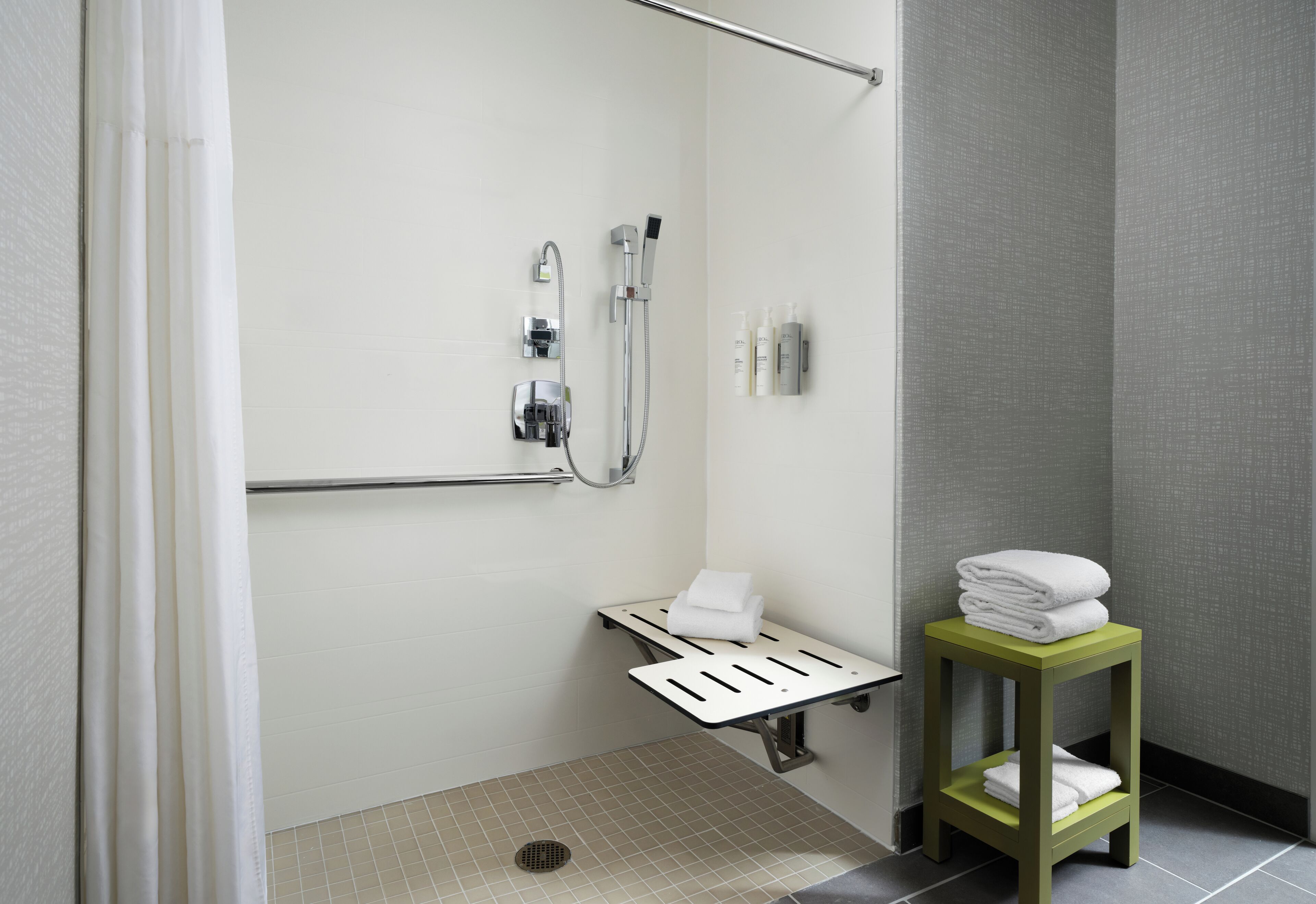 combined shower/bathtub, designer toiletries, hair dryer, towels