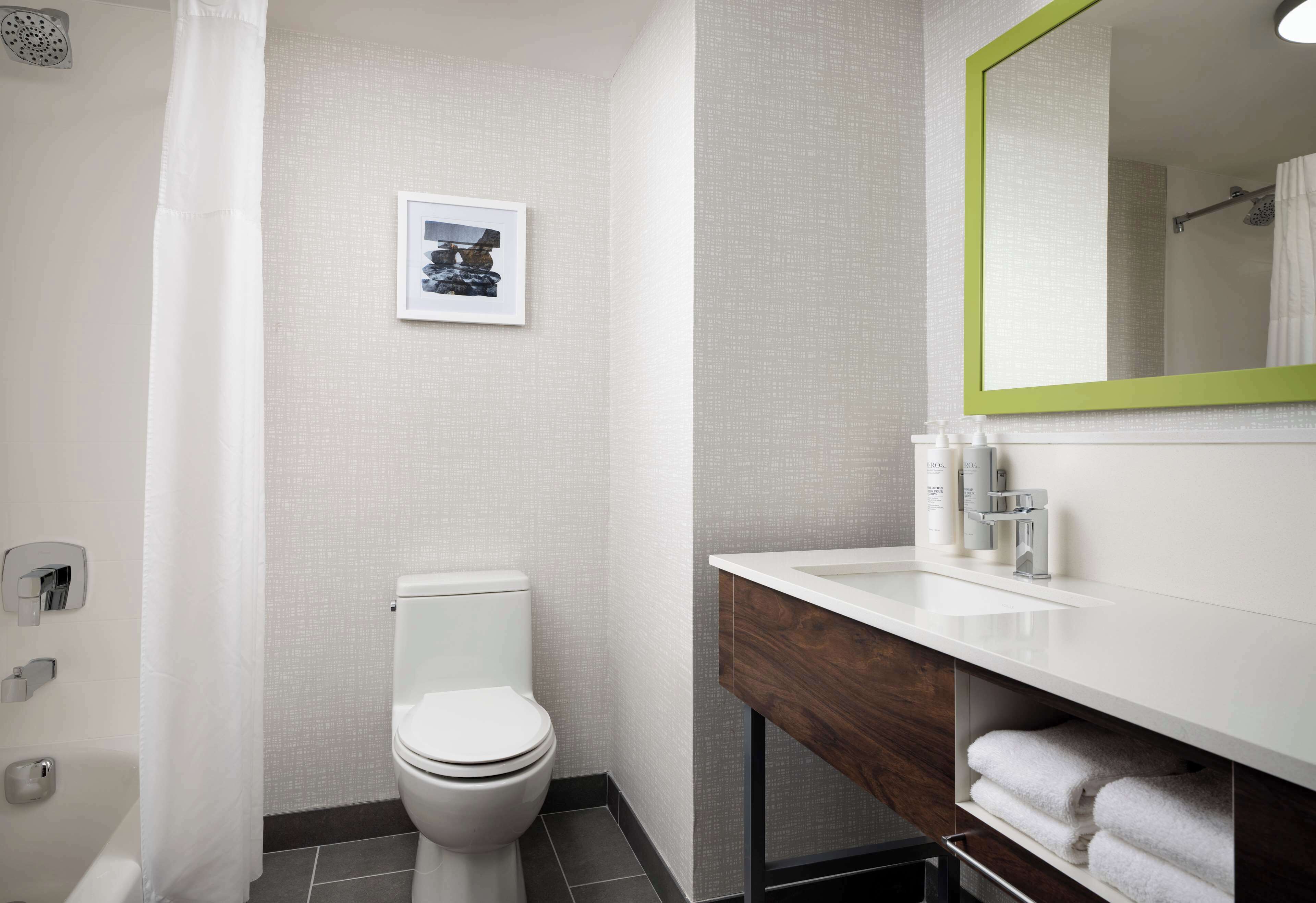 combined shower/bathtub, designer toiletries, hair dryer, towels