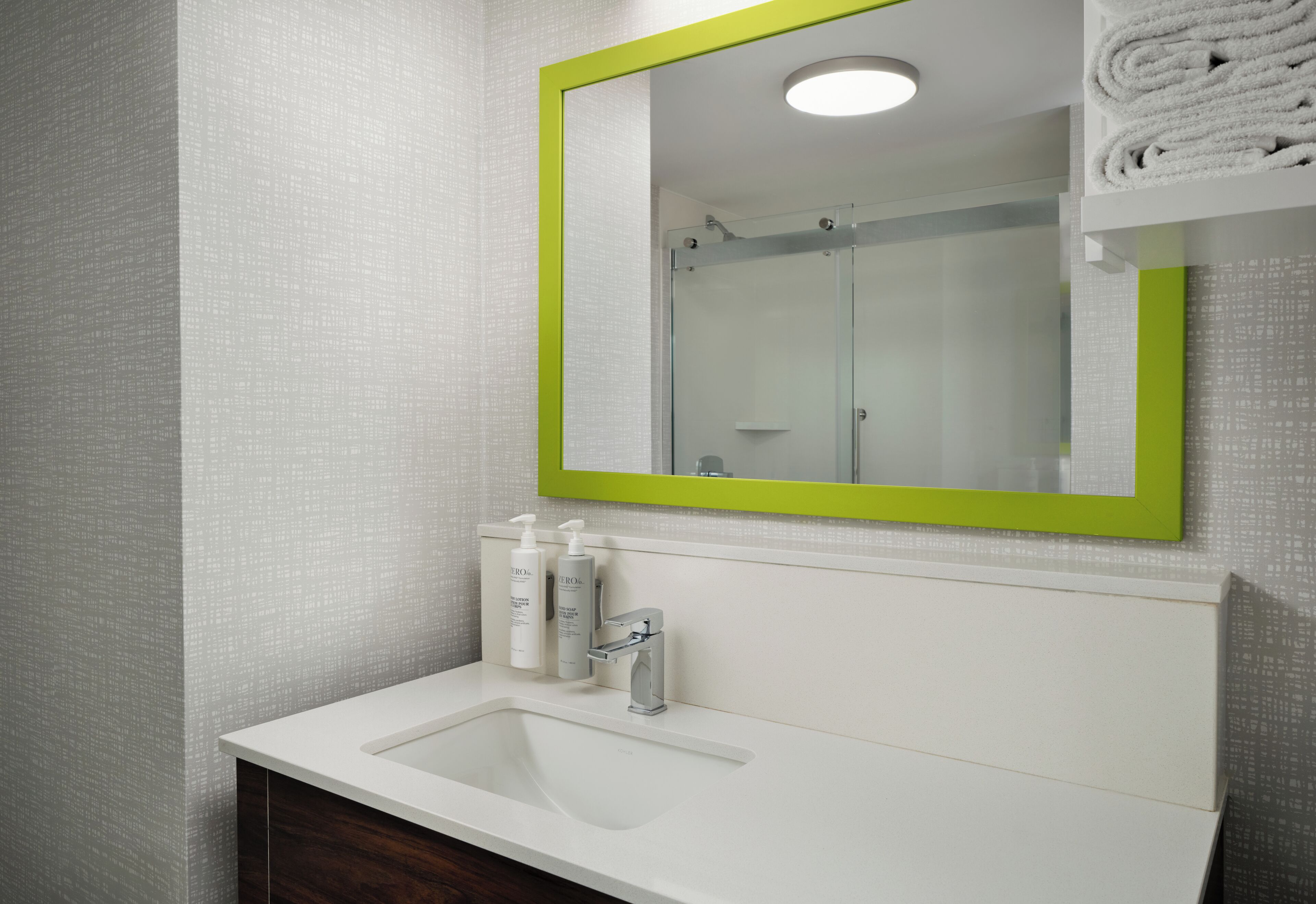 combined shower/bathtub, designer toiletries, hair dryer, towels