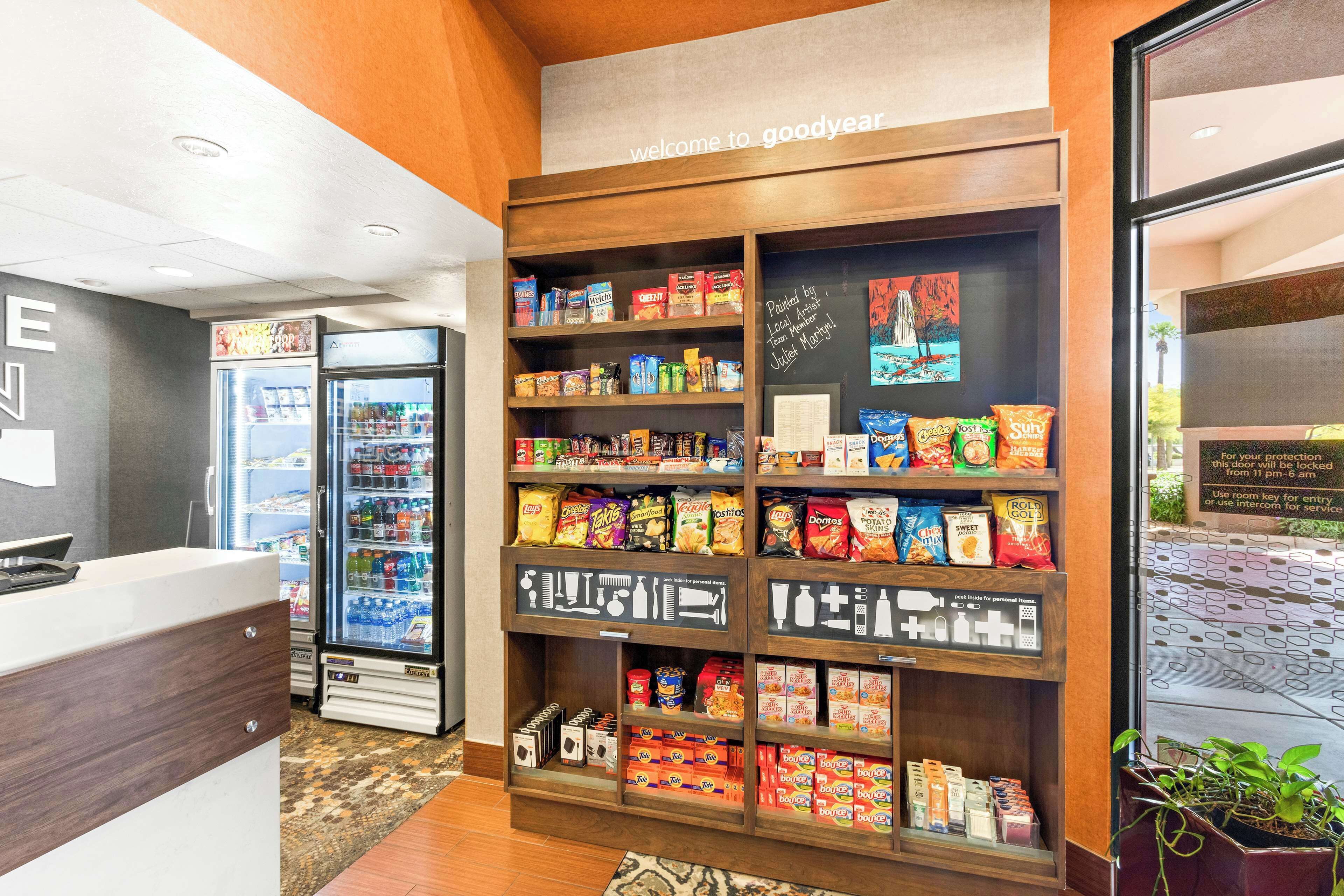 A Goodyear-branded snack display with various products, a reception area, and a refrigerator.